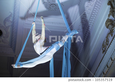 Speech gymnasts on the canvases. Girl on acrobatic canvases.Dangerous Circus Tricks.Aerial gymnast 105357519