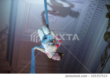 Speech gymnasts on the canvases. Girl on acrobatic canvases.Dangerous Circus Tricks.Aerial gymnast 105357523