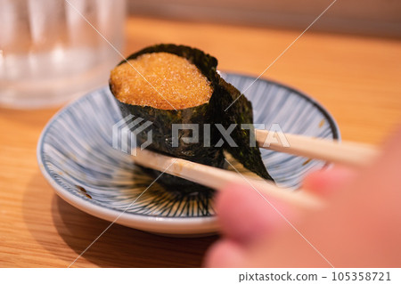 Japanese Gunkanmaki Sushi. Ice fish eggs. 105358721