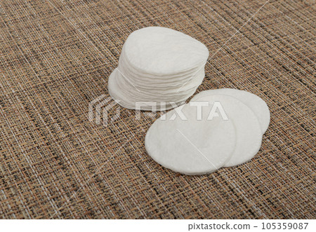 Cotton Disks, Hygiene Pads on Eco Linen Background, Round Facial Sponge, Soft Clear Disk Stack 105359087