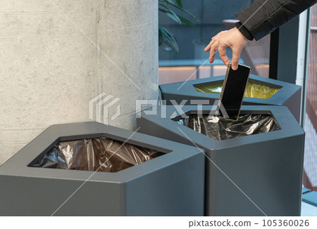 Throwing Out Smartphone, Put Electronic Device Into Trash Can, Throwed Away Smartphone 105360026