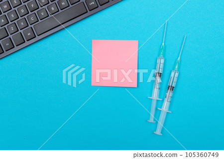Vaccination or Revaccination Concept - Two Medical Syringe on Blue Table Vaccination or Revaccination Concept - Two Medical Syringe on Blue Table 105360749
