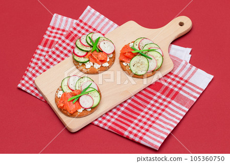 Cracker Sandwiches with Salmon, Cucumber, Radish, Cottage Cheese and Green Onions 105360750