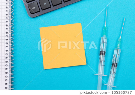 Vaccination or Revaccination Concept - Two Medical Syringe on Blue Table 105360787
