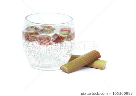 Glass of water with rhubarb pieces over white Glass of water with rhubarb pieces over white 105360992