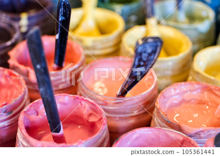 Large group of open cans of multi-coloured paints 105361441