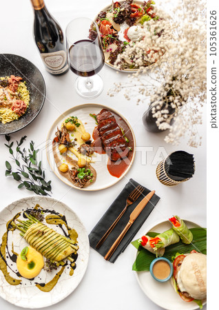 View from above of several plates of food. Variety of different dishes.  105361626
