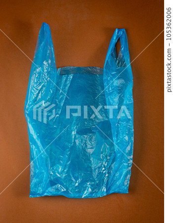 Blue Plastic Bags on Brown Background, Crumpled Plastic Bag after Shopping, Cellophane Packaging Waste Blue Plastic Bags on Brown Background, Crumpled Plastic Bag after Shopping, Cellophane Packaging Waste 105362006