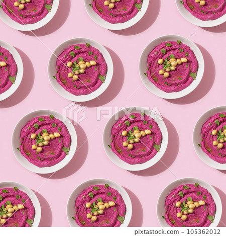 Pattern with beetroot hummus on pink background, top view 105362012