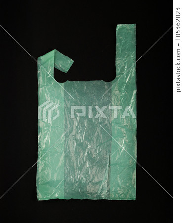 Green Plastic Bags on Black Background, Crumpled Plastic Bag after Shopping, Cellophane Packaging Waste Green Plastic Bags on Black Background, Crumpled Plastic Bag after Shopping, Cellophane Packaging Waste 105362023