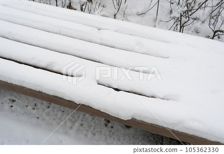 Wooden Bench in Snow, Frozen Winter Park, Outdoor City Architecture, Empty Plank Seat in Snowfall, Seasonal Travel Wooden Bench in Snow, Frozen Winter Park, Outdoor City Architecture, Empty Plank Seat in Snowfall, Seasonal Travel 105362330