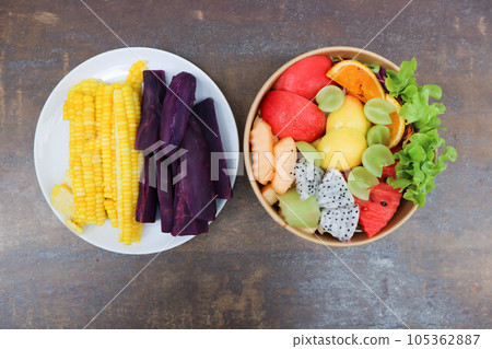 steamed corn and steamed purple sweet potato or fruit and vegetable salad or apple, dragon fruit and lettuce salad steamed corn and steamed purple sweet potato or fruit and vegetable salad or apple, dragon fruit and lettuce salad 105362887