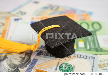 Graduation gap hat on Euro and US dollar banknotes money, Education study fee learning teach concept. 105363030