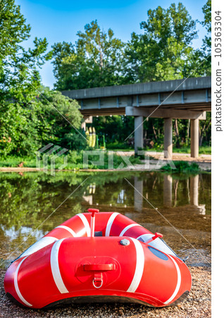 Single inflatable raft at the beginning of a float trip on a river.  105363304
