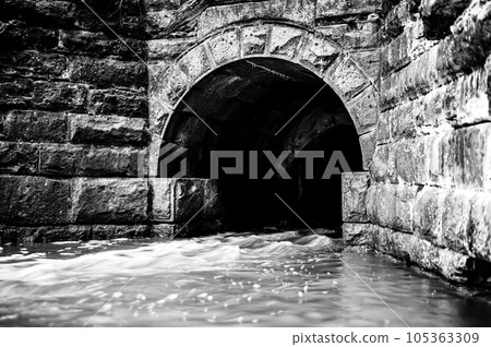 Old stone storm drainage sewer under a roadway. 105363309