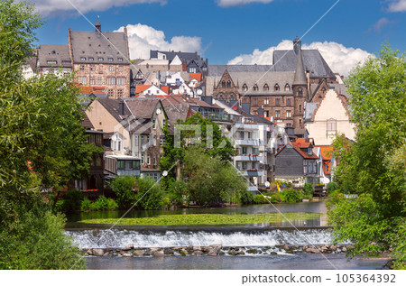 Old stone houses on the banks of the river Lahn in Marburg. 105364392