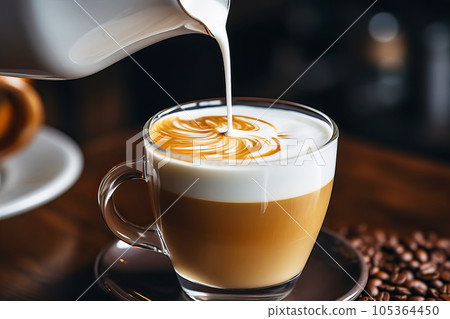 Professional barista pouring milk in coffee. Cooking latte art close-up 105364450