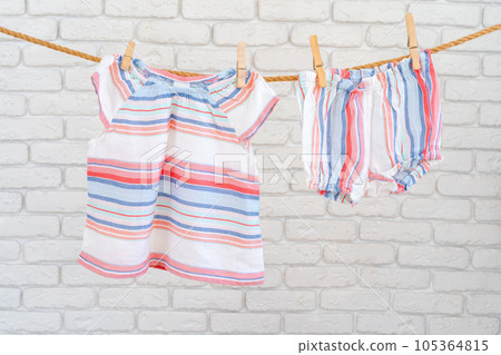 Cute toddler colorful clothing hang on a rope 105364815
