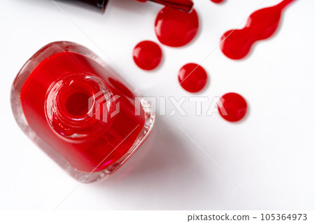Bright colored nail polish bottles with drippings on white background Bright colored nail polish bottles with drippings on white background 105364973