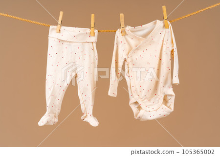 Kid's apparel pinned to a clothesline to dry 105365002