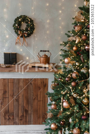 Home New Year's interior. Christmas tree with gifts, decorated with garlands in the kitchen. Cozy atmosphere of a home holiday, loft design of the room, Scandinavian style. Home New Year's interior. Christmas tree with gifts, decorated with garlands in the kitchen. Cozy atmosphere of a home holiday, loft design of the room, Scandinavian style. 105365322