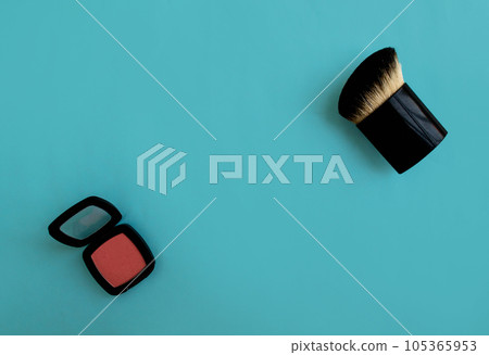 Brush and blush on a blue background. Background with copy space. Brush and blush on a blue background. Background with copy space. 105365953