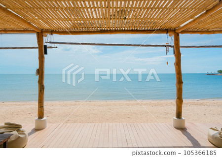Wooden terrace with roof boho style on the beach in tropical sea Wooden terrace with roof boho style on the beach in tropical sea 105366185