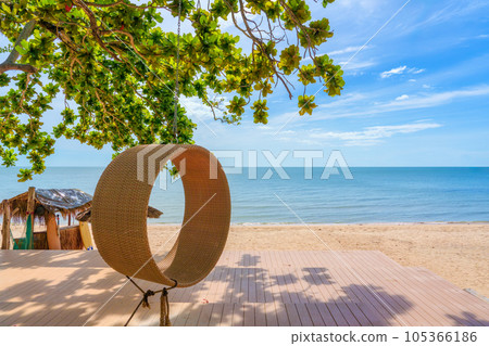 Tropical sea beach and wooden swing on terrace of the resort in summer 105366186