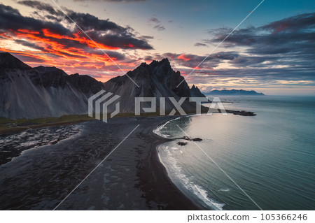 Dramatic sunset sky over Vestrahorn mountain and black sand beach in Stokksnes peninsula at Iceland 105366246