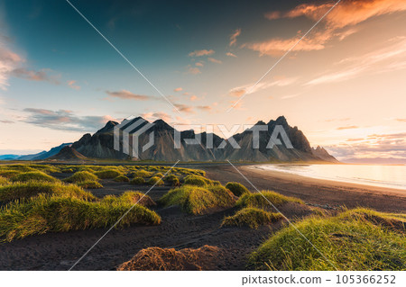 Sunrise dramatic sky over Vestrahorn mountain on black sand beach in Stokksnes peninsula at Iceland Sunrise dramatic sky over Vestrahorn mountain on black sand beach in Stokksnes peninsula at Iceland 105366252