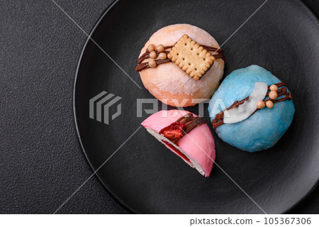 Delicious sweet colorful mochi desserts or ice cream with rice dough and toppings Delicious sweet colorful mochi desserts or ice cream with rice dough and toppings 105367306