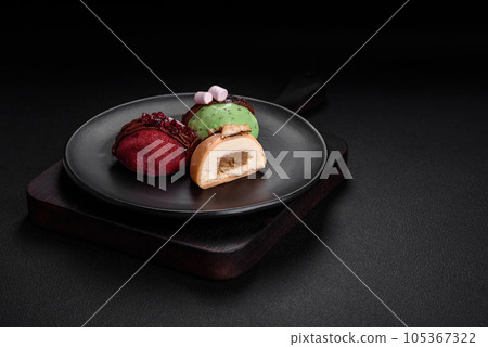 Delicious sweet colorful mochi desserts or ice cream with rice dough and toppings Delicious sweet colorful mochi desserts or ice cream with rice dough and toppings 105367322