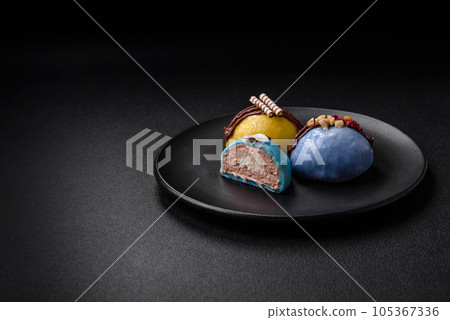 Delicious sweet colorful mochi desserts or ice cream with rice dough and toppings Delicious sweet colorful mochi desserts or ice cream with rice dough and toppings 105367336