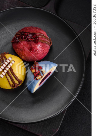Delicious sweet colorful mochi desserts or ice cream with rice dough and toppings Delicious sweet colorful mochi desserts or ice cream with rice dough and toppings 105367358