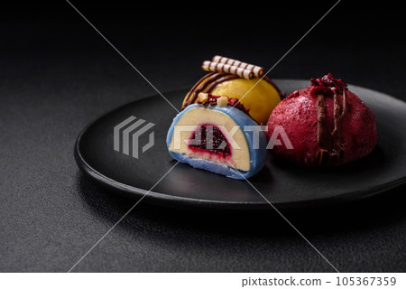 Delicious sweet colorful mochi desserts or ice cream with rice dough and toppings Delicious sweet colorful mochi desserts or ice cream with rice dough and toppings 105367359