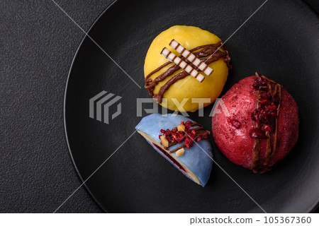 Delicious sweet colorful mochi desserts or ice cream with rice dough and toppings Delicious sweet colorful mochi desserts or ice cream with rice dough and toppings 105367360