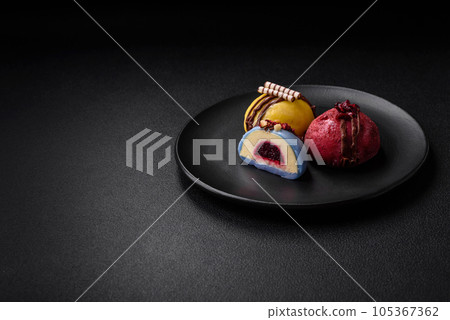 Delicious sweet colorful mochi desserts or ice cream with rice dough and toppings 105367362