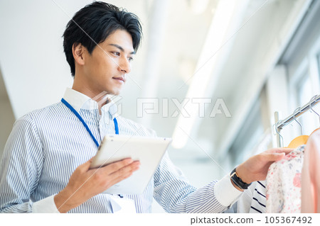 Male clerk checking products 105367492