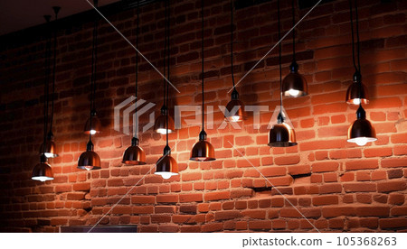 background of burning light bulbs on a brick wall background background of burning light bulbs on a brick wall background 105368263