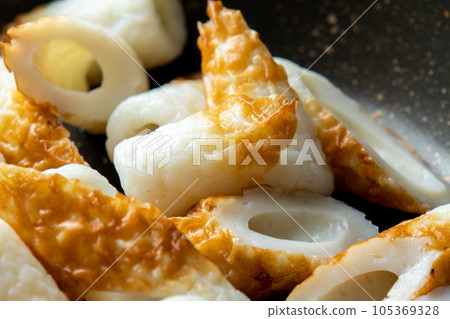 Close-up of the cooking scene of frying chikuwa in a frying pan. Close-up of the cooking scene of frying chikuwa in a frying pan. 105369328