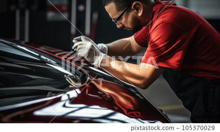Car wrapping specialist putting vinyl foil or film on car. Selective focus. Car wrapping specialist putting vinyl foil or film on car. Selective focus. 105370029