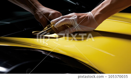 Car wrapping specialist putting vinyl foil or film on car. Selective focus. Car wrapping specialist putting vinyl foil or film on car. Selective focus. 105370035