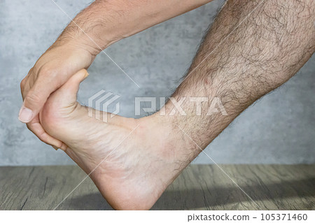 Grabbing a toe and stretching a muscle Grabbing a toe and stretching a muscle 105371460