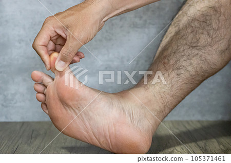 The sole of a man's foot stretching his muscles with his big toe The sole of a man's foot stretching his muscles with his big toe 105371461