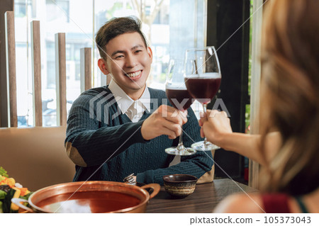 Young couple celebrating toasting restaurant. Young couple celebrating toasting restaurant. 105373043