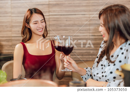girlfriends raise a toast with glasses 105373050