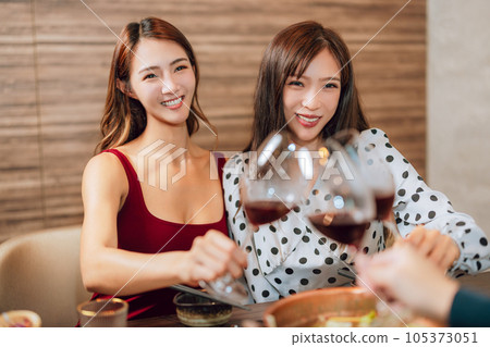 girlfriends raise a toast with glasses girlfriends raise a toast with glasses 105373051