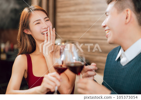 Young couple celebrating wine glasses restaurant. Young couple celebrating wine glasses restaurant. 105373054
