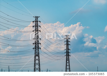 Transmission towers and cumulonimbus clouds in the blue sky of a summer afternoon c-3 light tone Transmission towers and cumulonimbus clouds in the blue sky of a summer afternoon c-3 light tone 105373065