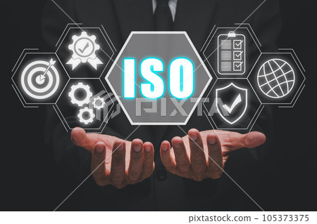 ISO standards quality control concept, Person hand holding iso icon on virtual screen on desk workplace, Assurance warranty, Business technology concept. ISO standards quality control concept, Person hand holding iso icon on virtual screen on desk workplace, Assurance warranty, Business technology concept. 105373375